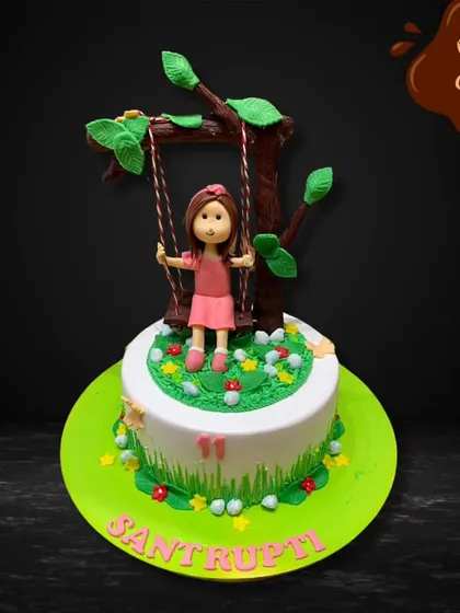 A simple and charming cake showing a girl on a swing under a tree. This design is perfect for celebrating a love of nature and the simple joys of childhood.