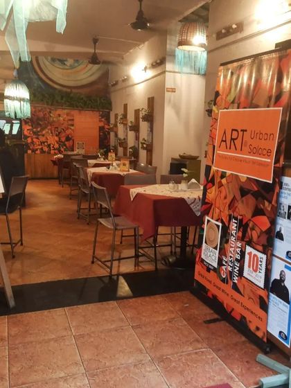 The inviting entrance to our cafe, set up for an art exhibition. Art is woven into the very fabric of our space.