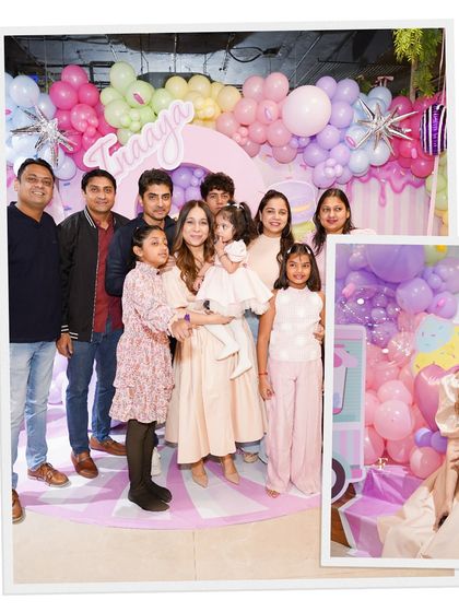 A large family group posing in front of a beautiful pastel balloon backdrop. Our spacious venue is perfect for bringing the whole extended family together to celebrate.
