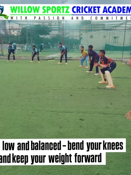 The first rule of fielding: stay low and balanced. This image demonstrates the correct ready position for a fielder.