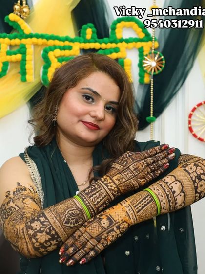 This bride looks absolutely radiant, proudly displaying her stunning bridal mehndi.