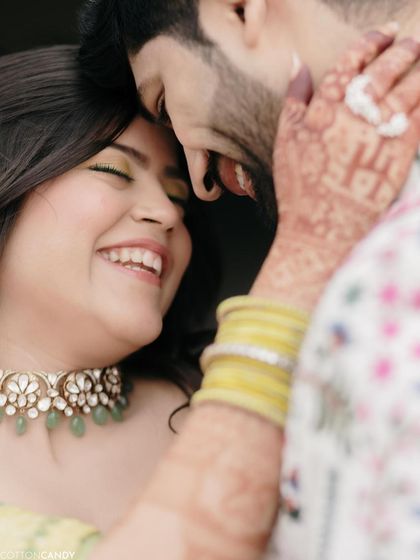 A close-up of the Haldi bride's infectious smile. The makeup is kept fresh and minimal, with a pop of yellow on the eyes to match the festive vibe.