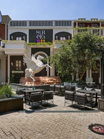 A key part of my work is integrating statement art. At Street 1522, this large Pegasus sculpture serves as a dramatic water feature and a central landmark for the entire courtyard, demonstrating how I blend landscape architecture with bold artistic elements.