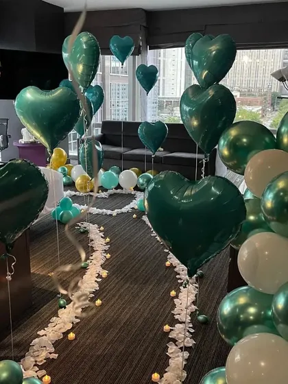 A different angle of the teal room decor, highlighting the floating heart balloons and the city view from the window.
