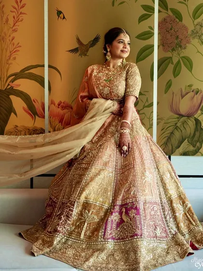 The bride's lehenga in full, glorious display. The makeup was kept soft and luminous to balance the magnificent embroidery and colors of her outfit.