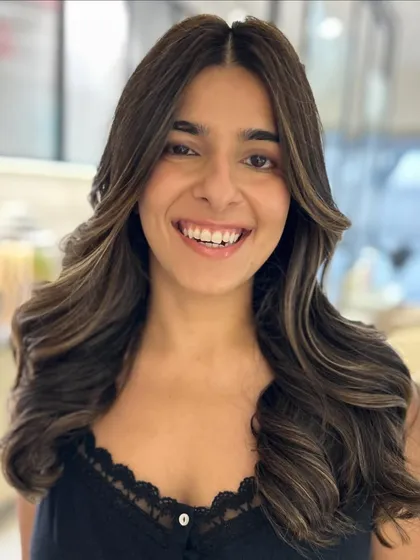 A two-tone balayage on a natural dark brown base. The lighter pieces around the face create a beautiful face-framing effect.
