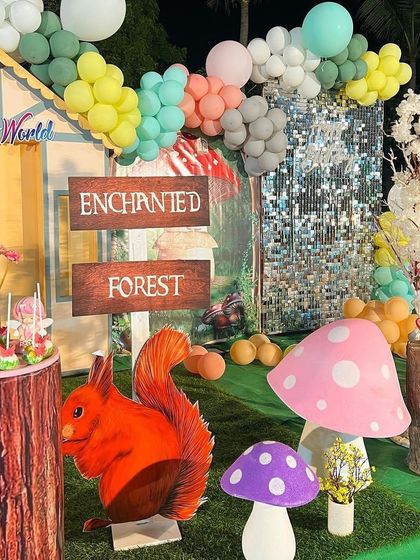 A close-up of the Enchanted Forest theme, with a silver sequin wall, a squirrel cutout, and whimsical mushroom props.