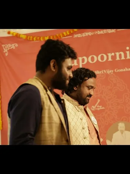 Sharing a moment with a fellow artist on stage during the Gurupoornima event. Music is often a collaborative art.