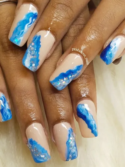 Another angle of the ocean wave nails, showing the depth and movement in the hand-painted art. Perfect for a beach vacation.