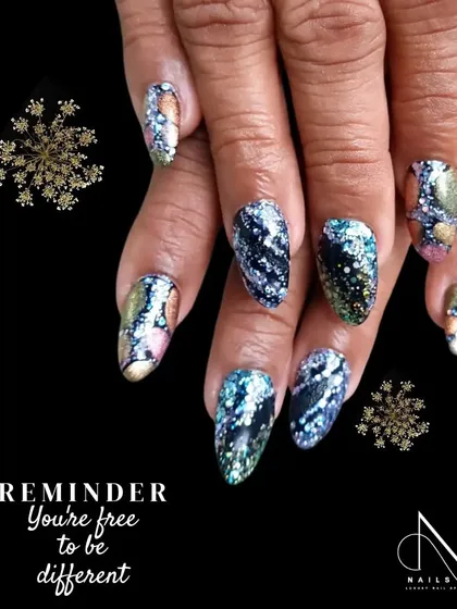 A dark and mesmerizing glitter design. We used a black base and applied a multi-colored, iridescent flakie glitter for a galaxy-like effect.
