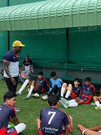Our UEFA and AFC licensed coaches provide direct feedback and mentorship. Here, our U17 squad gets tactical instructions during a training session.