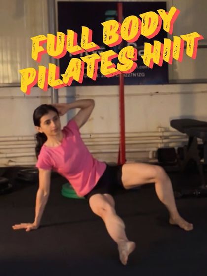 A powerful image from a full-body Pilates HIIT session. This side plank with a crunch is an intense move that sculpts the obliques and challenges your endurance.