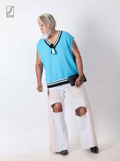 A dynamic, off-balance pose that adds energy and movement to the studio shot.