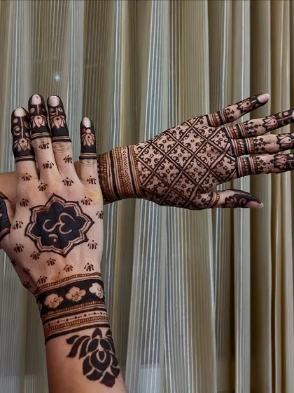 Showcasing my versatility with two distinct styles. One hand features a modern, bold Om symbol within a lotus mandala, while the other displays a classic, intricate checkerboard (jaal) pattern.