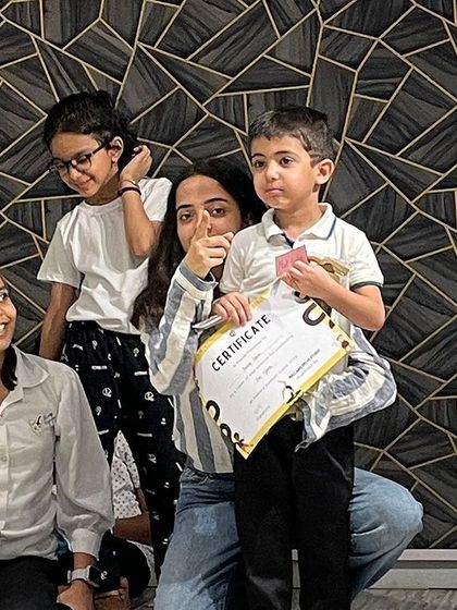 A thumbs-up for a successful summer camp! This little guy is proudly holding his certificate after the final performance. These are the moments we cherish.
