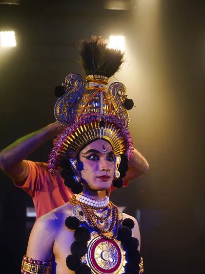 Preparing for my role in the dance theatre production of "Kāla - The God of Death". This shows the detailed makeup and costuming process that helps transform me into a character, blending dance with theatrical elements.