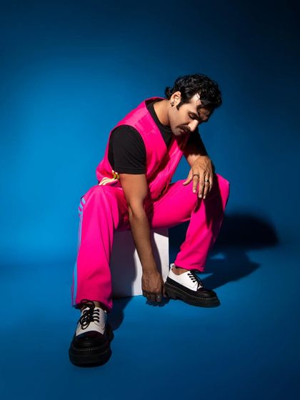 A pensive, seated pose that creates a more thoughtful and artistic mood for a menswear lookbook.