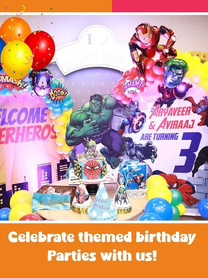 A full view of our action-packed superhero theme. The backdrop features Hulk and Iron Man, with a cake table ready for the celebration.