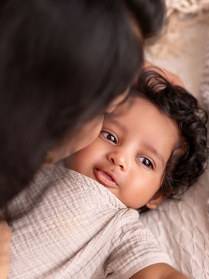 A mother's gentle kiss. This close-up shot focuses on the tender connection between a mom and her baby.