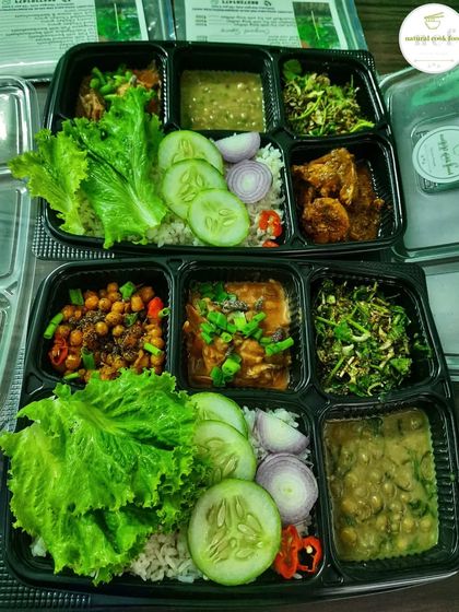 A side-by-side view of my fully loaded Veg and Chicken thalis, ready for delivery.