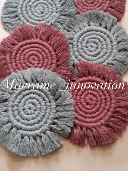 A lovely set of macrame coasters in dusty rose and grey. The spiral design and fringed edges are a classic boho touch for your home decor.