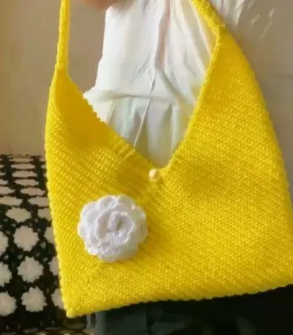 Here is the yellow crochet bag being modeled. You can see its stylish, slouchy shape and how it hangs beautifully.
