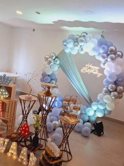 The same setup for Ivaan's birthday in brighter light, showing the soft blue and silver colors of the balloons.