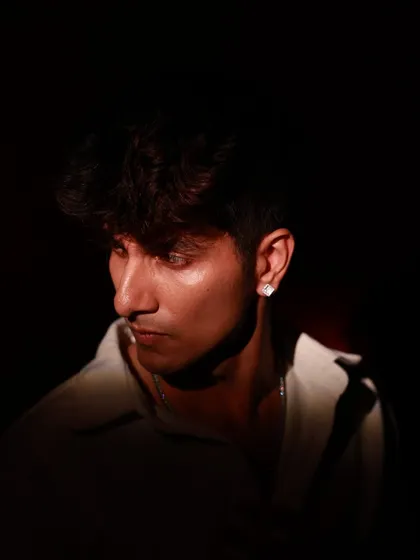 A low-key portrait of the male model, with most of his face in shadow for a mysterious effect.