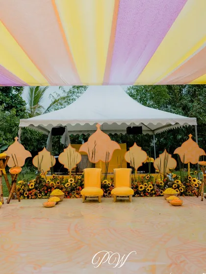 A splash of yellow for the perfect Haldi moment. This setup features a canopy of yellow and lilac drapes with a simple, modern stage, letting the vibrant colors shine.