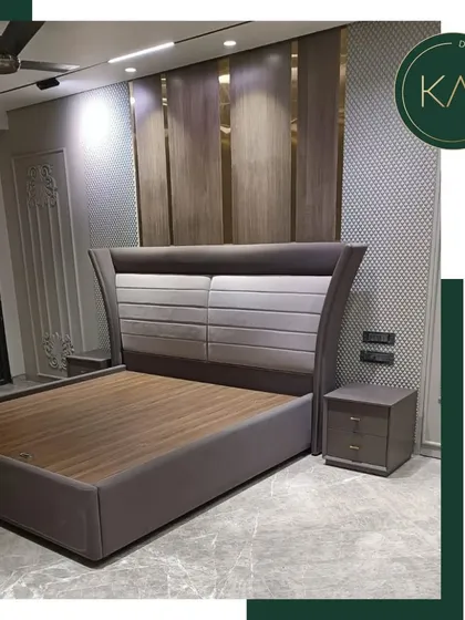 A full view of a bedroom project in South City 1, featuring a bed with a curved, two-tone upholstered headboard. The design combines different textures and tones to create a sophisticated and visually interesting piece.