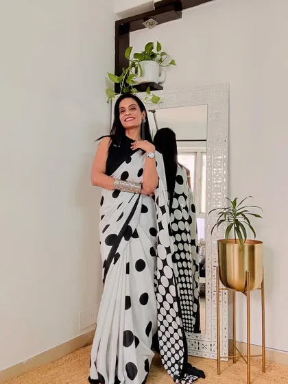A classic black and white polka dot satin saree is always in style. This one has a fun, retro vibe and is perfect for a chic party look.