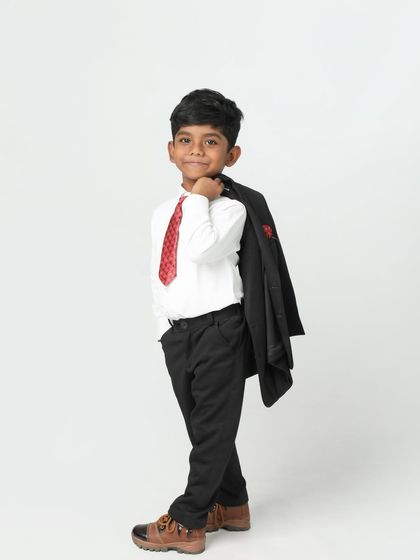 Looking like a cool boss! This young boy has so much style and confidence, with his jacket slung over his shoulder. A fun and modern kid's portrait.