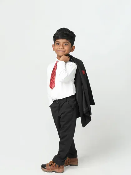Looking like a cool boss! This young boy has so much style and confidence, with his jacket slung over his shoulder. A fun and modern kid's portrait.