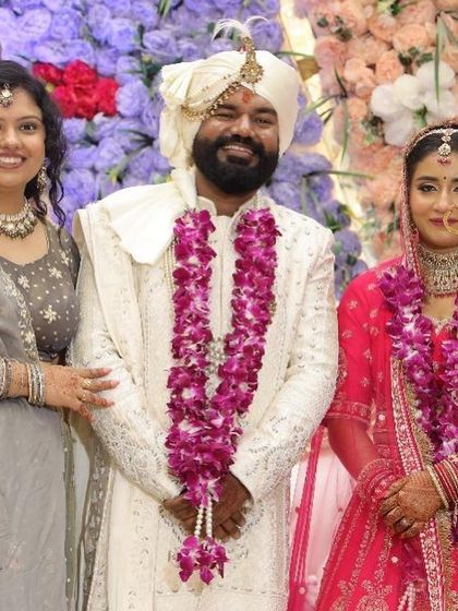 The bride, groom, and a family member, all smiles.
