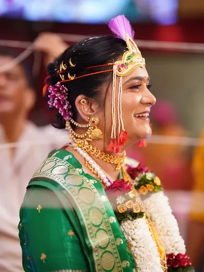 A candid moment of joy during the wedding ceremony. The bride's makeup remains flawless even in her happiest moments, showcasing its durability and natural finish.