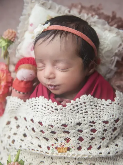 Tucked in with a crochet blanket and a tiny doll, this baby looks so cozy. I love adding small, handmade details to make each session unique.