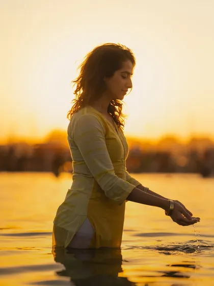 Offering the sacred water of the Ganga back to its source. This simple act of reverence is a way of acknowledging the life-giving power of the river and the divinity within all of nature.