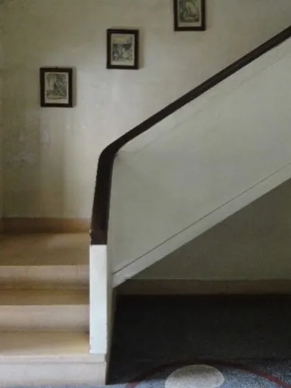 The simple elegance of the original staircase, with its clean lines and minimalist handrail, a feature we will carefully preserve.