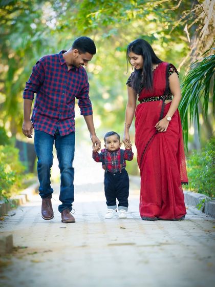 The whole family taking their little one for a walk. This is a beautiful way to symbolize their journey together as a family.