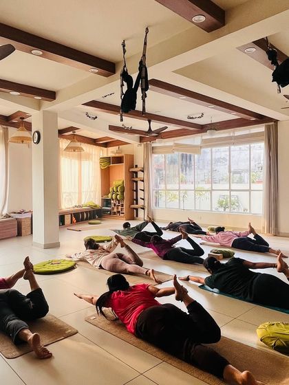 Students hold Bow Pose, a deep backbend that requires both strength and flexibility.