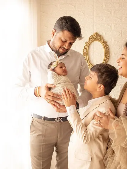 A complete family portrait welcoming the newest member. The big brother's loving gaze at his new baby sister is just heartwarming.