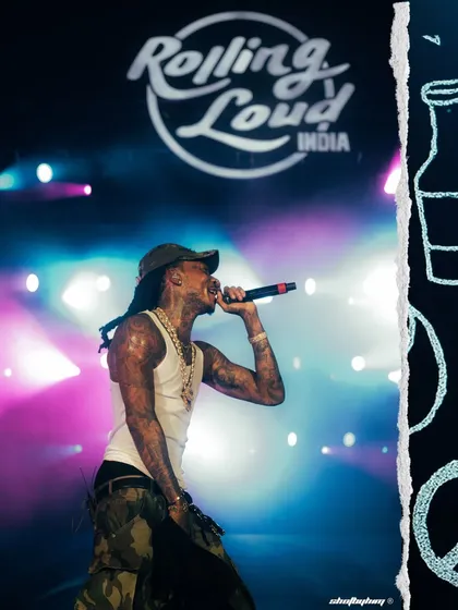 A full-body shot of Wiz Khalifa commanding the stage at Rolling Loud India. The festival branding is clearly visible, providing context and scale to the performance.