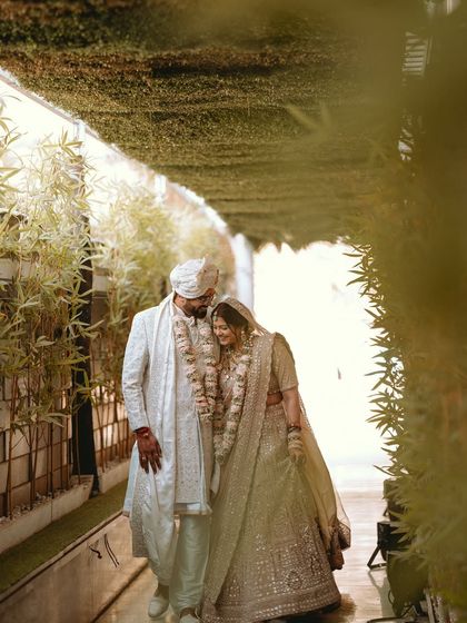 A candid walking shot of the couple, sharing a moment of peace and togetherness after the wedding rituals.