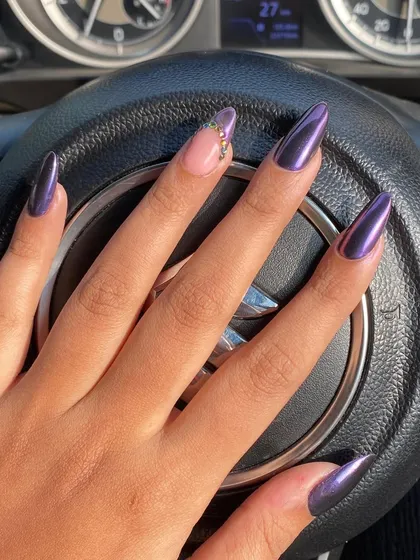 A deep, moody purple chrome set with a single accent nail featuring delicate rhinestone details.