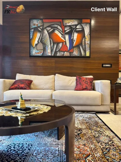 We believe art should not just hang on a wall, it should live in the space. This abstract figurative work by Jagannath Paul, 'Togetherness', brings warmth, emotion, and a modern aesthetic to our client's living room, perfectly complementing the rich wooden textures and creating a focal point for conversation.