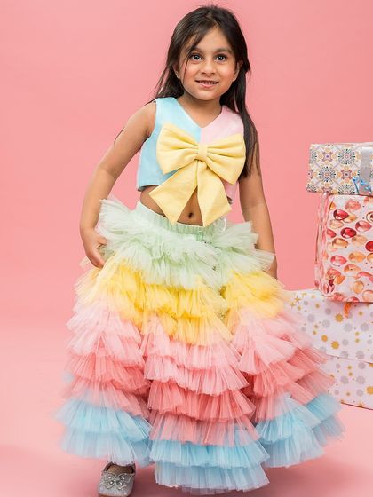 A full view of the rainbow ruffled skirt and top, a perfect outfit for a colorful birthday theme.