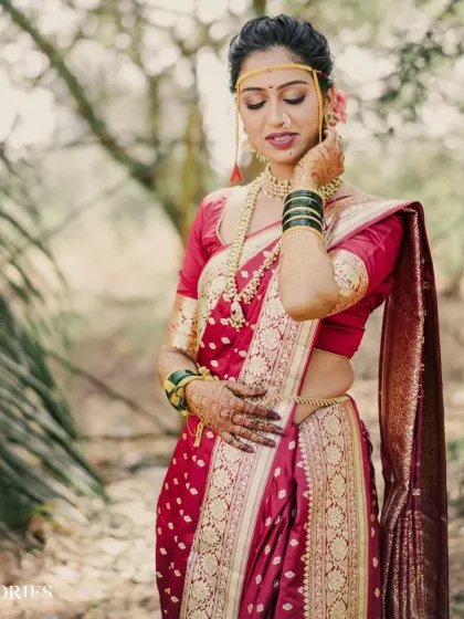 A beautiful full-length shot of the bride, showcasing the grace of the nauvari saree and her elegant posture.