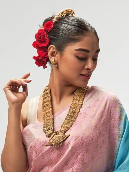 A closer look at the Aadhya collection reveals the unique texture of the silk linen fabric. This image highlights the intricate weave and the beautiful way the saree drapes, complemented by traditional jewelry that enhances its timeless appeal.