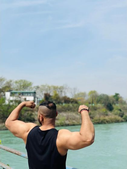 Flexing my biceps against the beautiful natural backdrop of Rishikesh.