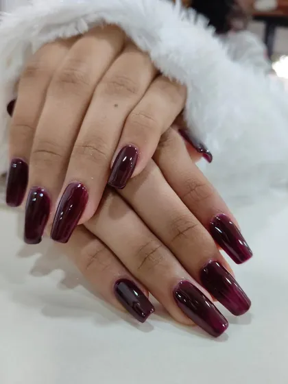 Your nails are a canvas. This deep wine, glossy manicure is perfect for making a statement, whether at a festive event or in the boardroom. It’s a sophisticated and confident look, like the perfect red lipstick for your hands.